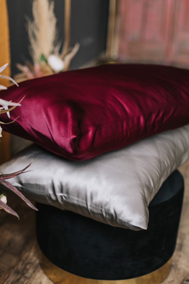 bordeoux and silver pillowcase on pillow on the chair